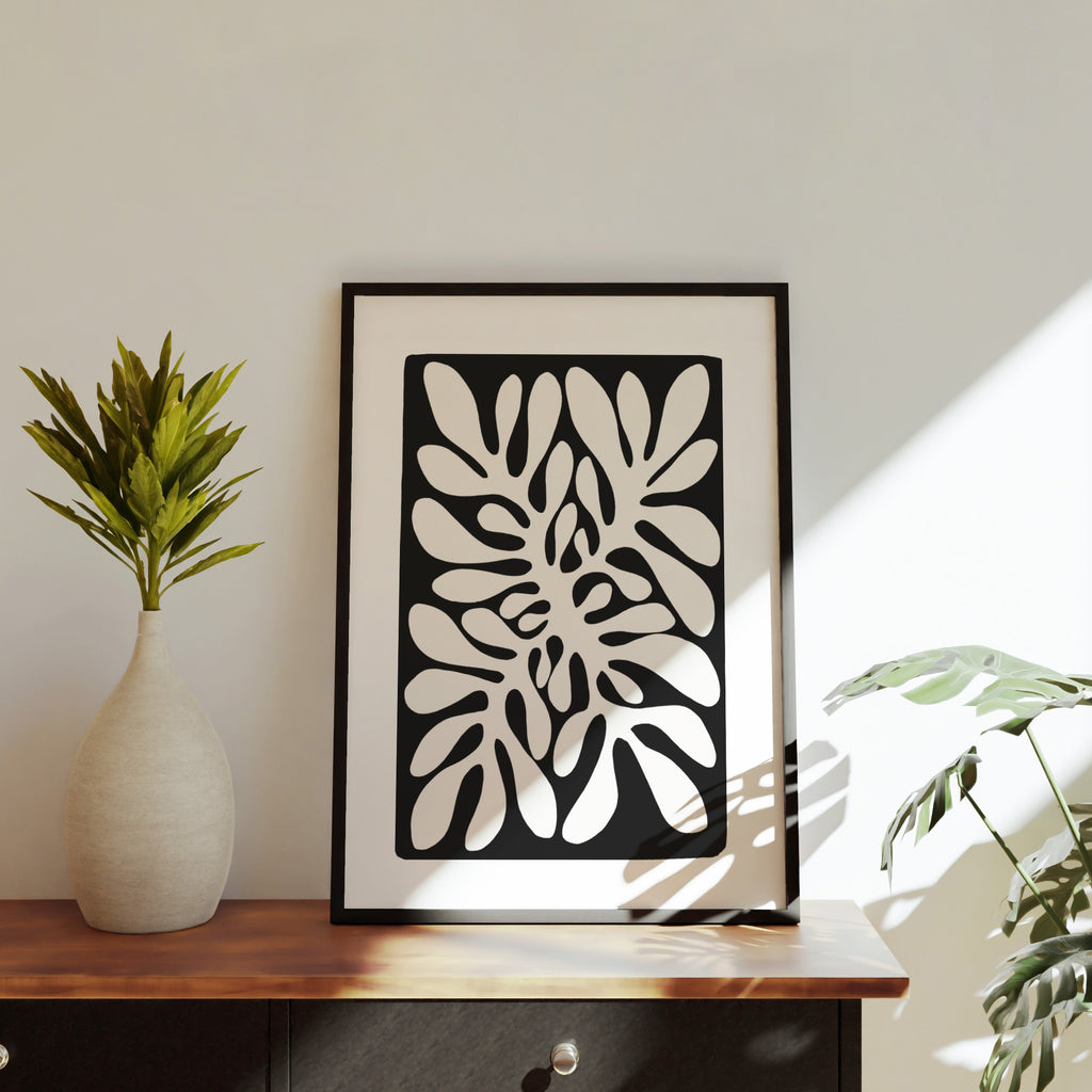 Wall art print of a coral pattern, leaning against a white wall.