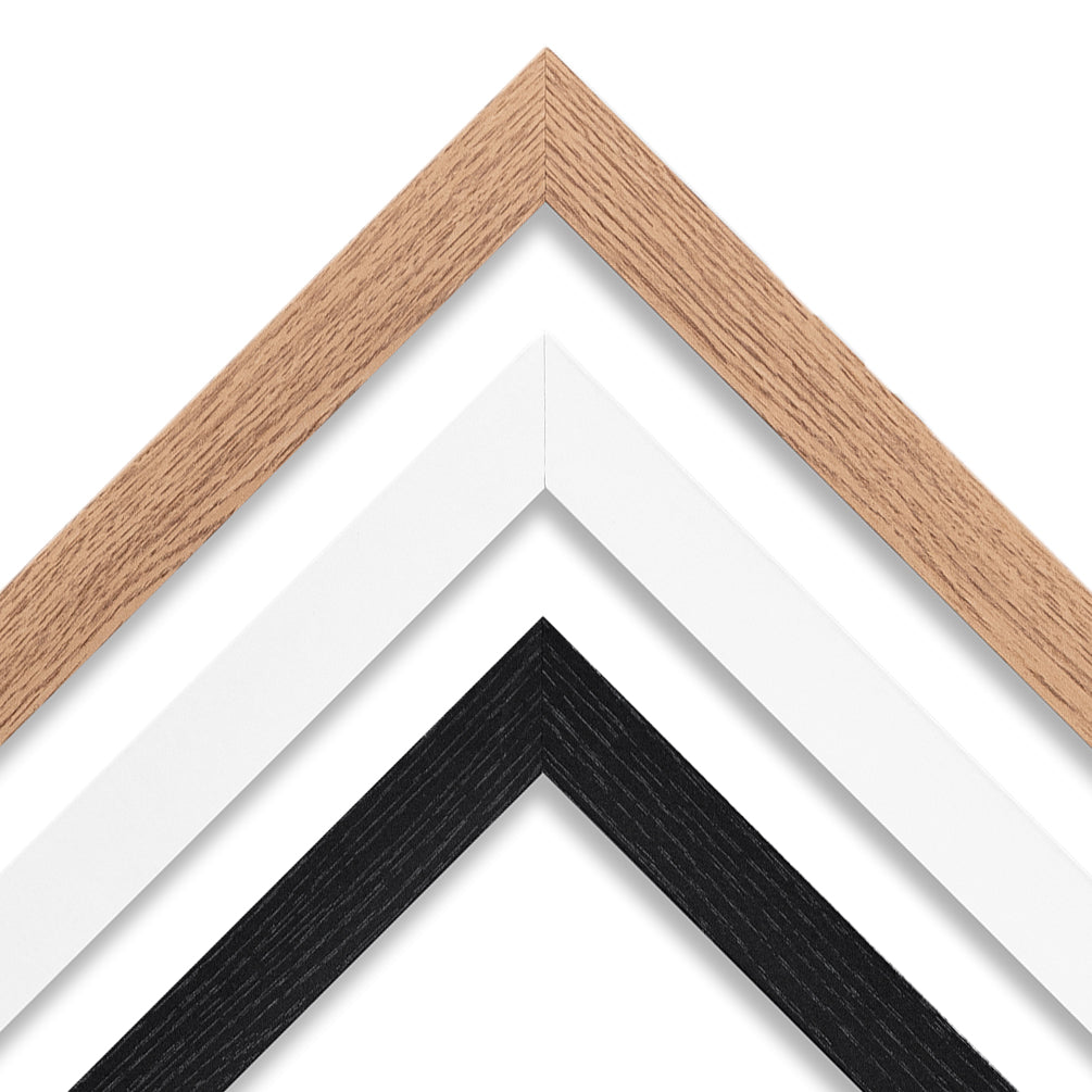 A close up photo of oak, white and black frames for wall art prints.