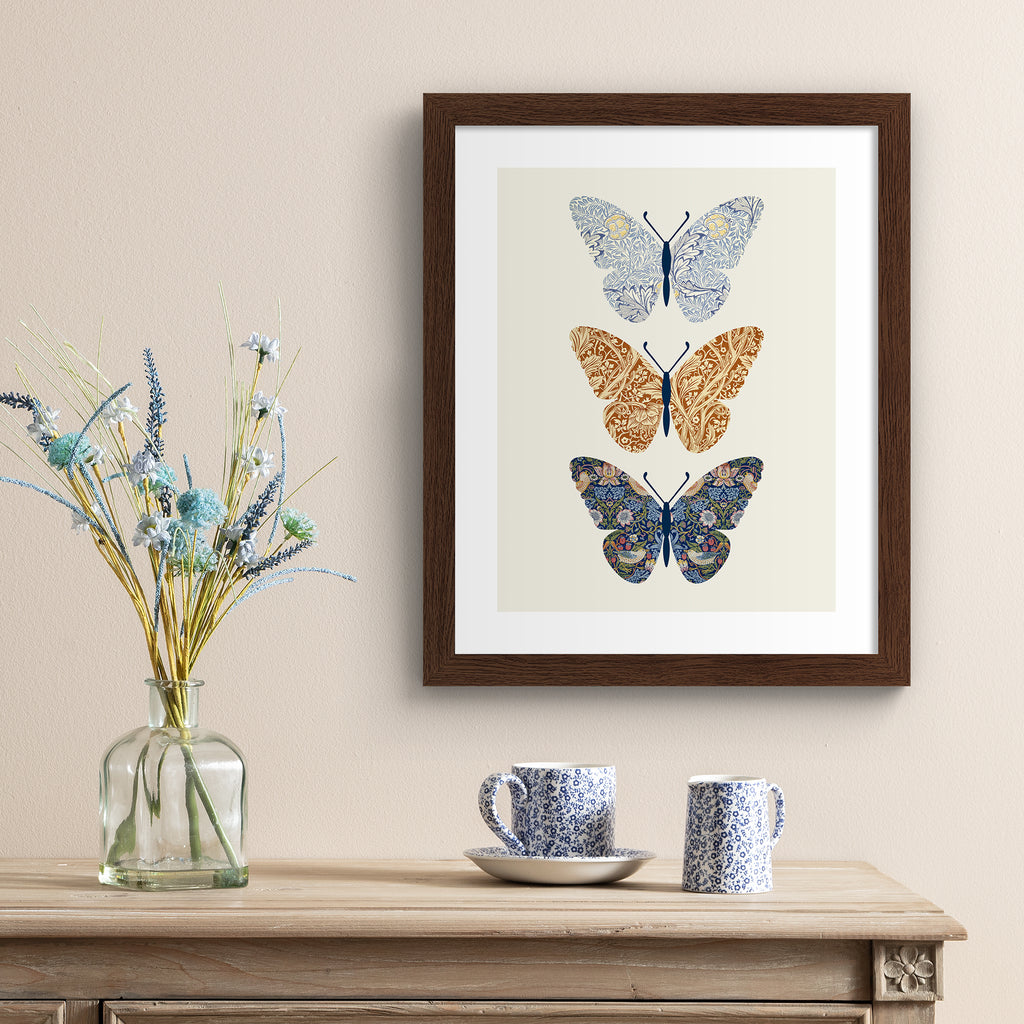 Floral butterfly set of 3 art print, hung up on a cream wall.