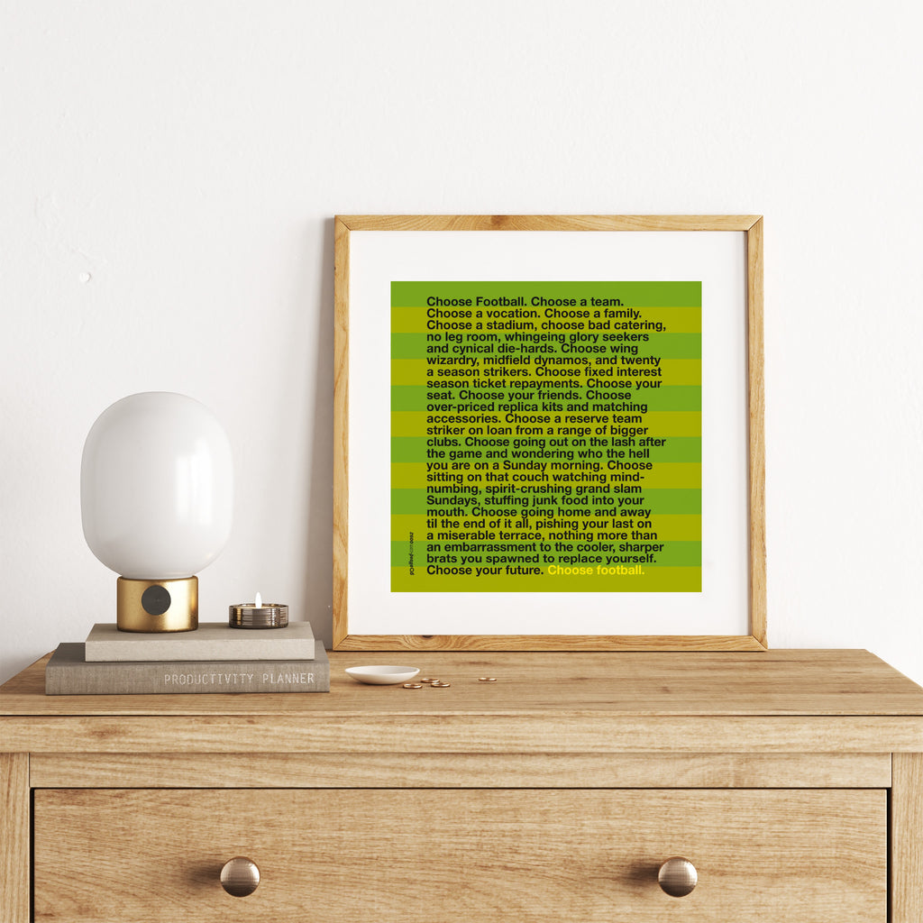 Sporty art print featuring typography celebrating football, on a bright green background. Art print is leaning on a chest of drawers.