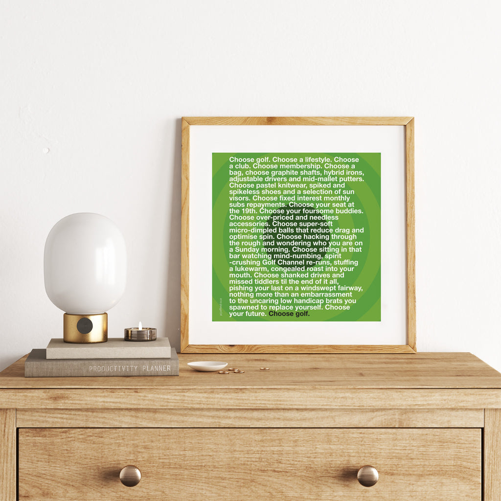 Sporty art print featuring typography celebrating golf, on a bright green background. Art print is on a chest of drawers.