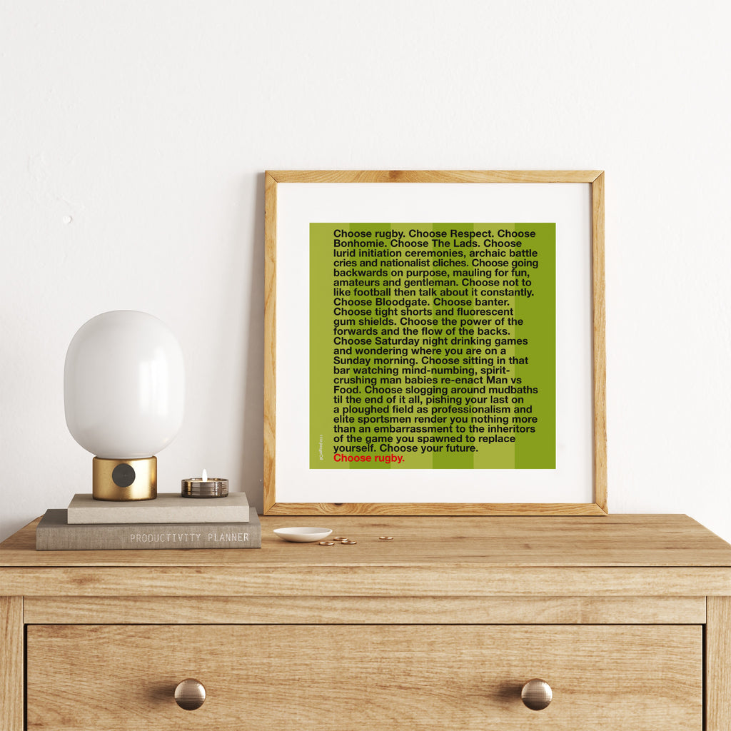 Sporty art print featuring typography celebrating golf, on a bright green background. Art print is leaning on a chest of drawers.