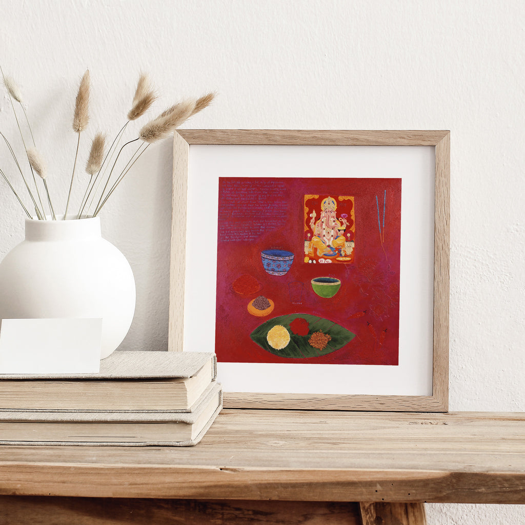 Abstract art print containing a breakfast spread of different pieces of food, on a bright red background. Art print is leaning against a white wall on a table.