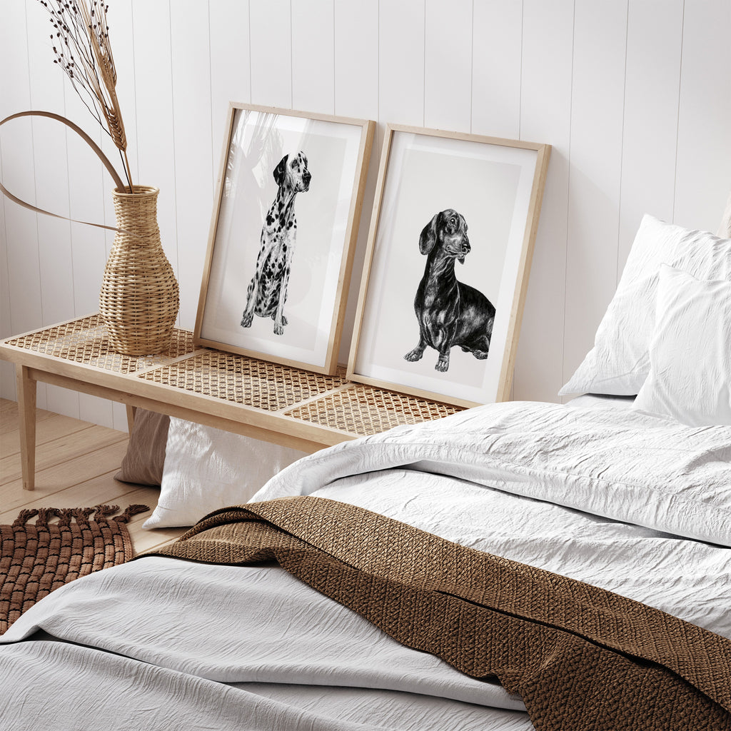 Black and white illustration featuring a detailed drawing of a Dachshund dog. Art print is leaning against a wall in a bedroom.