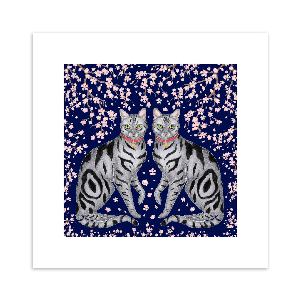 Art print of symmetrical striped cats surrounded by sakura blossoms and a deep blue background.