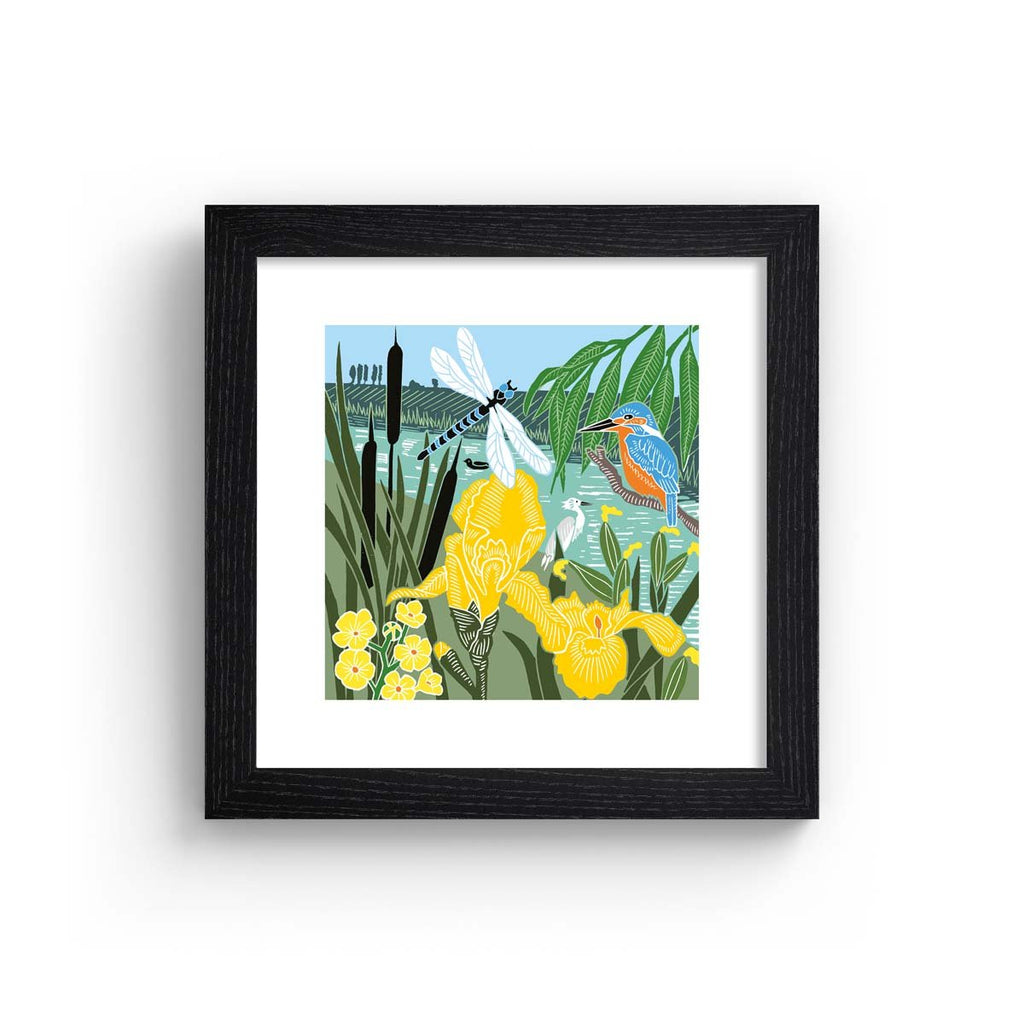 Beautiful art print containing a picturesque Summer waterside scene, featuring animals and botanicals frolicking in the greenery. Art print is in a black frame.