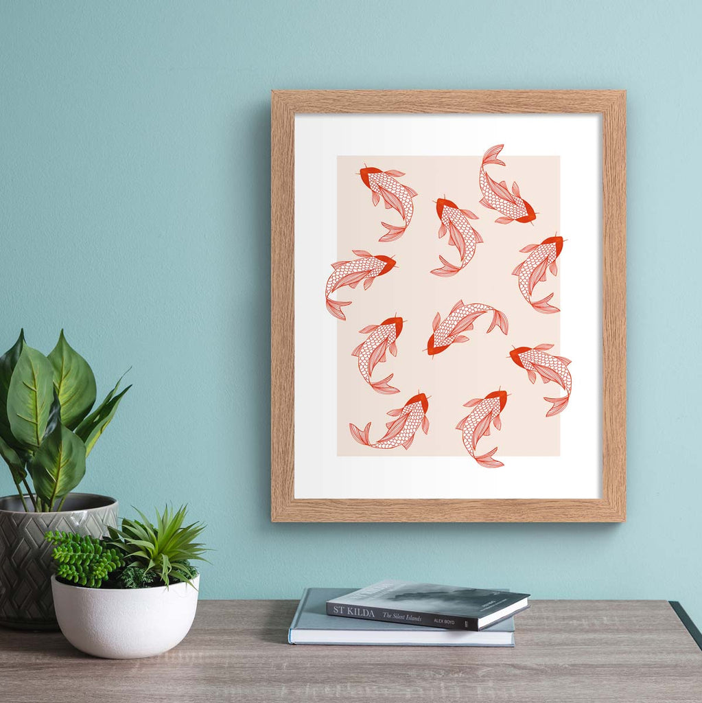 Pastel art print featuring a patterned illustration of pink koi, on a pale pink background. Art print is hung up on a bright blue wall.
