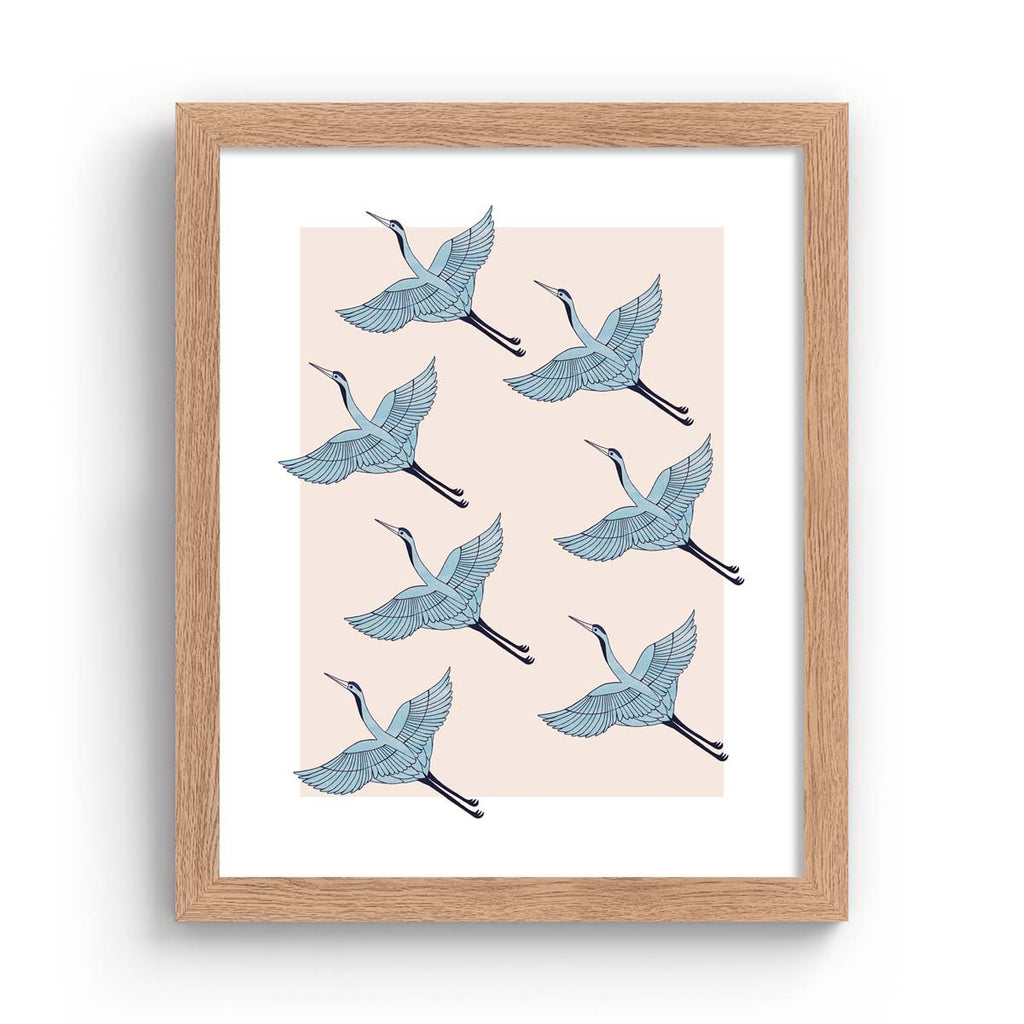 Detailed art print featuring a pattern of heron's flying in formation, on a pale pink background. Art print is in an oak frame.