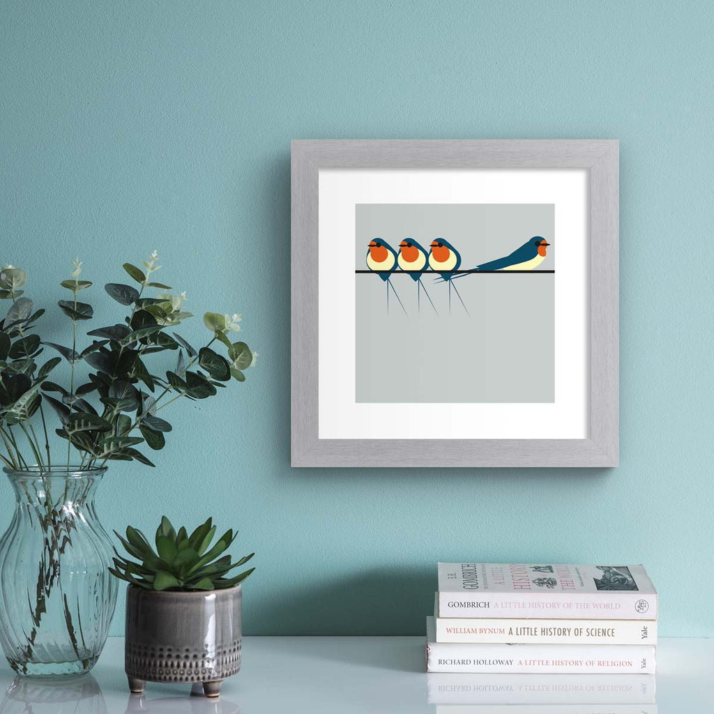 Minimalistic art print featuring three swallows perching on a line, in front of a blue background. Art print is hung up on a blue wall.