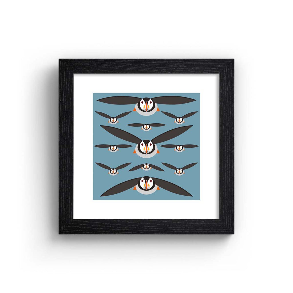 This minimalistic art print features a brilliant pattern of puffins flying in formation.  Art print is in a black frame.