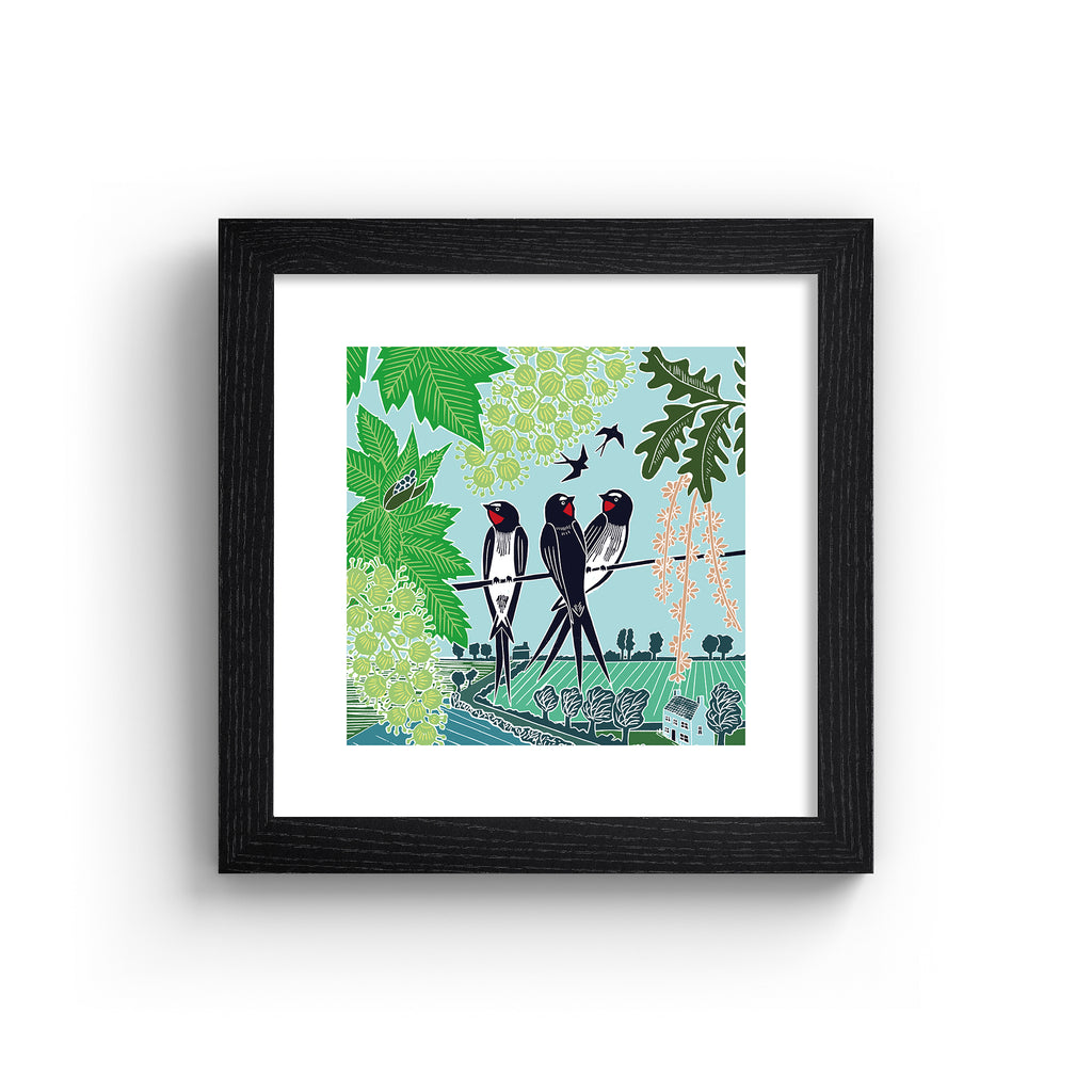 Emotive art print featuring three swallows perching on a branch above a beautiful Summer nature scene. Art print is in a black frame.