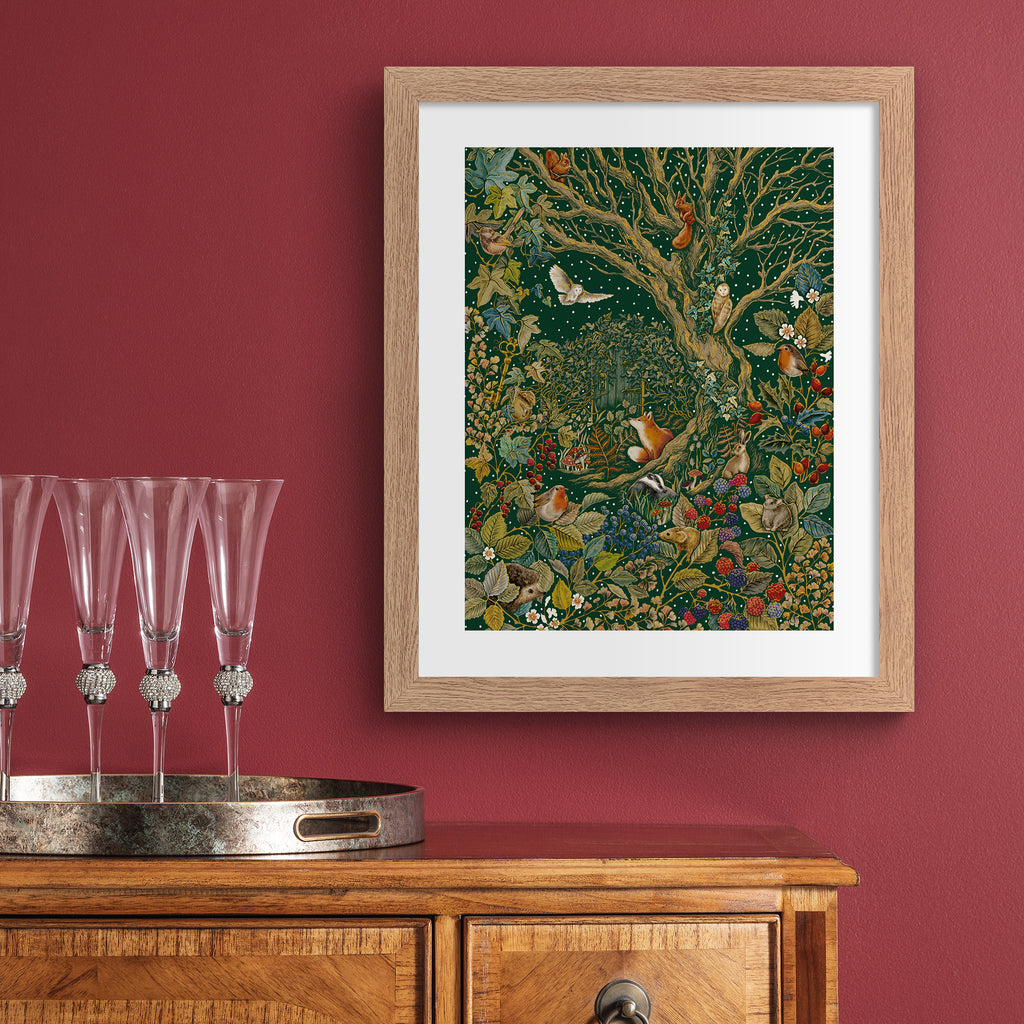 Stunning art print featuring a collection of British wildlife and botanicals in an atmospheric nature scene. Art print is hung up on a red wall.