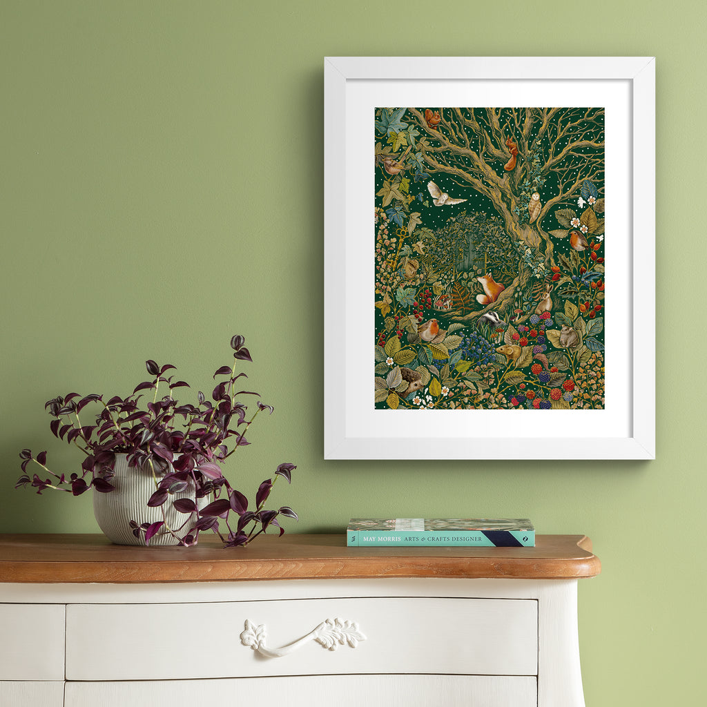 Stunning art print featuring a collection of British wildlife and botanicals in an atmospheric nature scene. Art print is hung up on a green wall.