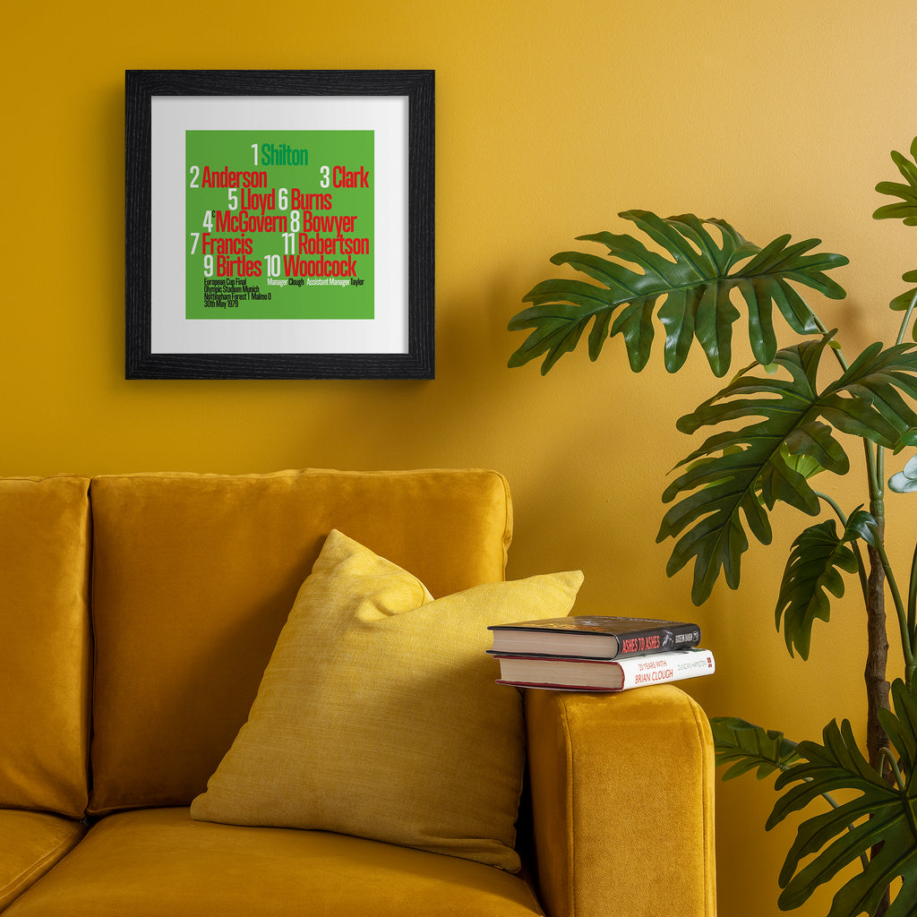 Colourful art print celebrating the Nottingham Forest 1979 Team, on a bright green background, with red, black and green typography. Art print is hung up on an orange wall.