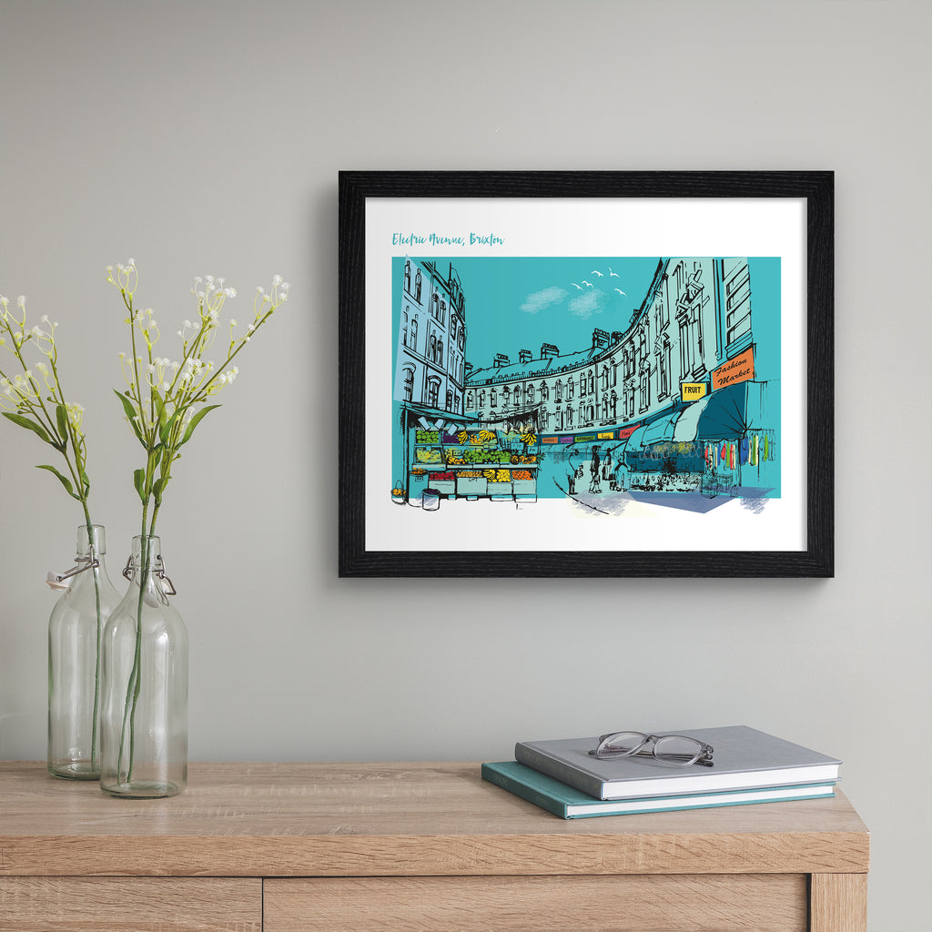 Bright blue art print featuring a detailed illustration of Electric Avenue in London. Text in the top left hand corner reads 'Electric Avenue, Brixton'. Art print is hung up on a grey wall.