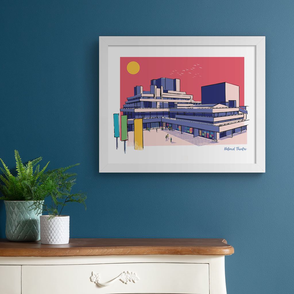 Colourful travel art print featuring the National Theatre in London, in vivid pastel colours. Title in the bottom right hand corner reads 'National Theatre'. Art print is hung up on a blue wall.