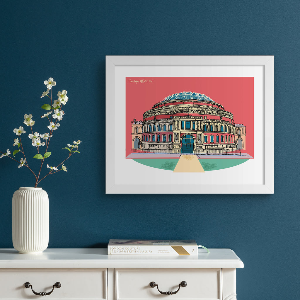 Vibrant travel art print featuring The Royal Albert Hall in London, in front of a bright pink background. Title in the top left reads ' The Royal Albert Hall'. Art print is hung up on a dark blue wall.