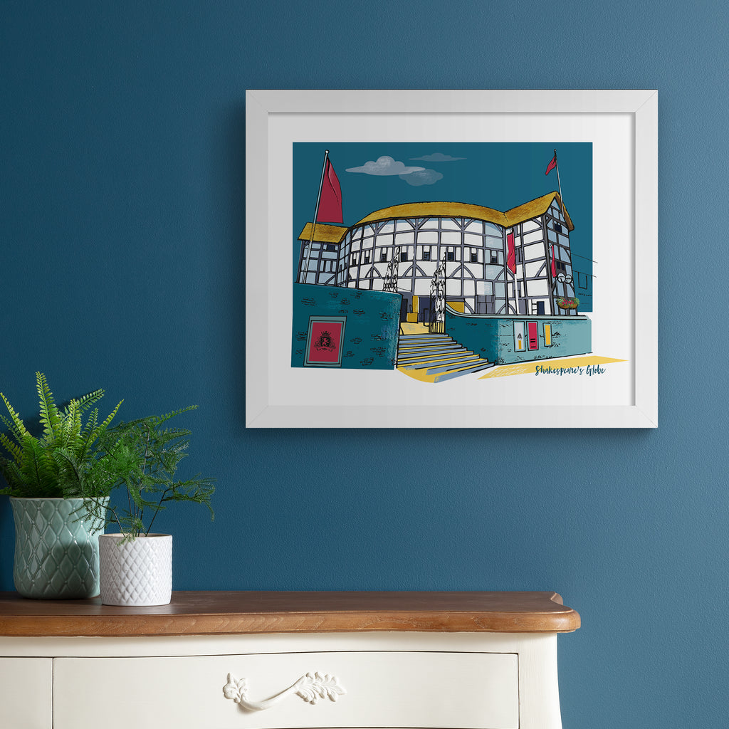 Colourful travel art print featuring Shakespeare's Globe in London, amidst a brilliant blue sky. Bottom right hand corner title reads 'Shakespeare's Globe'. Art print is hung up on a dark blue wall.