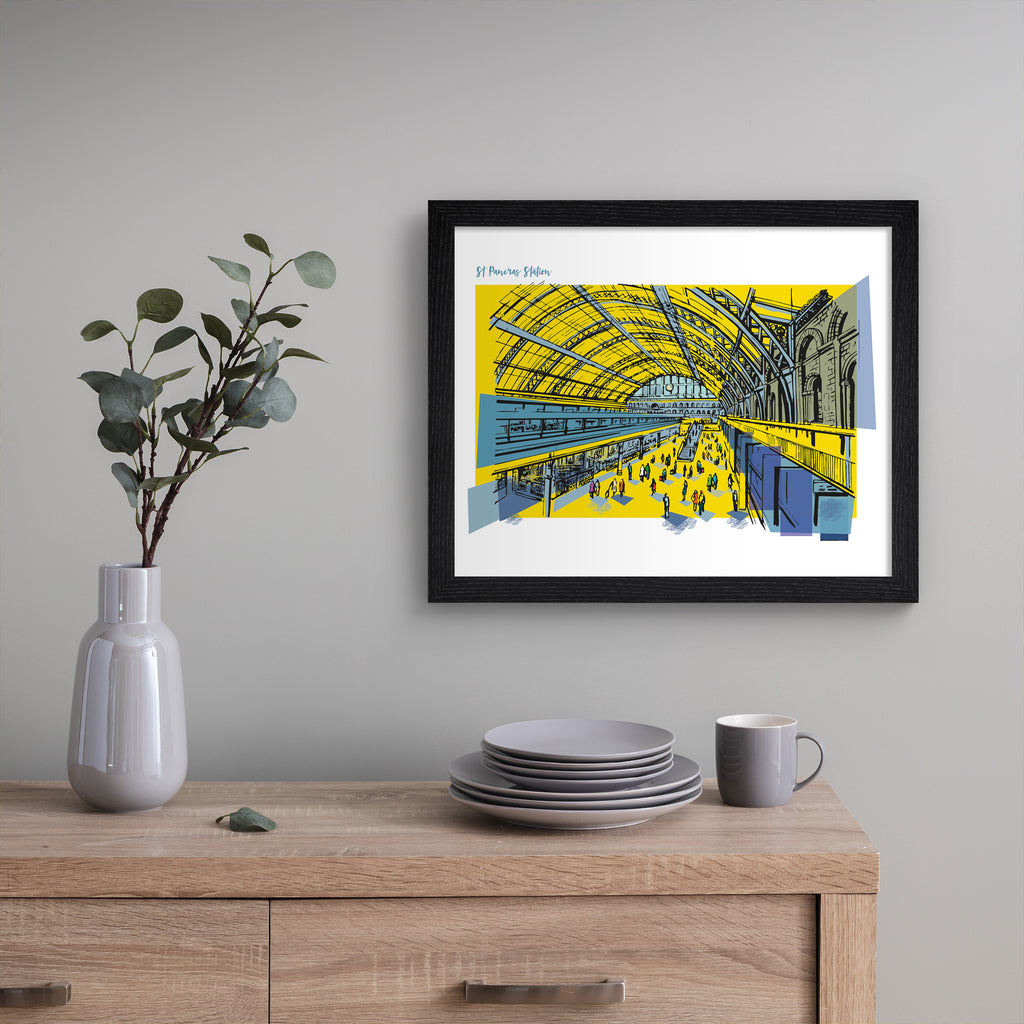 Striking travel art print featuring St Pancras Station in London, amidst a brightly coloured yellow background. Title in the top left reads 'St Pancras Station'. Art print is hung up on a beige wall.