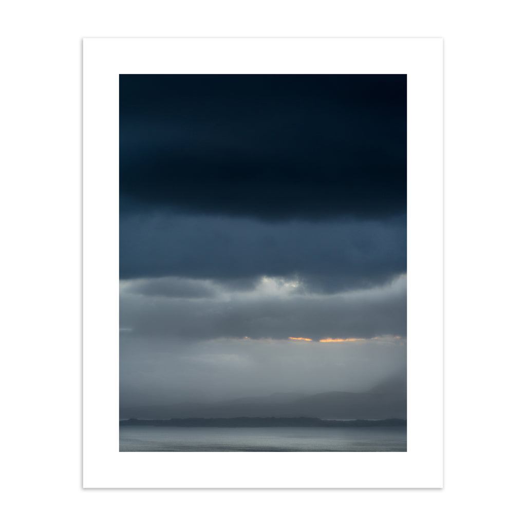 Photography art print featuring a vivid, cloudy sunrise over moody waters. 