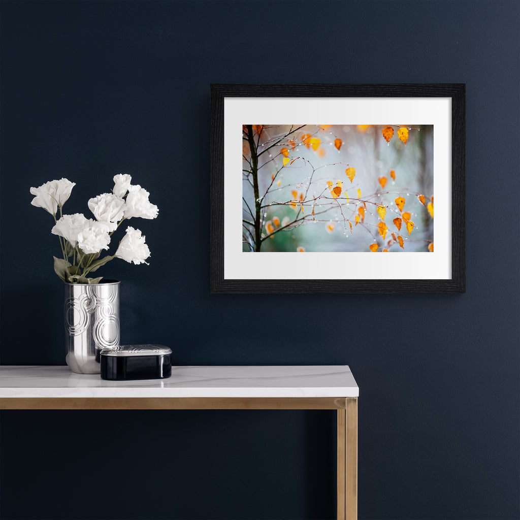 Photography art print featuring an Autumnal tree dripping with frost. Art print is hung up on a dark blue wall.