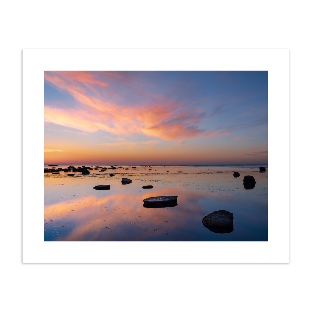 Stunning photography art print featuring a vivid sunrise over a reflective beach. 