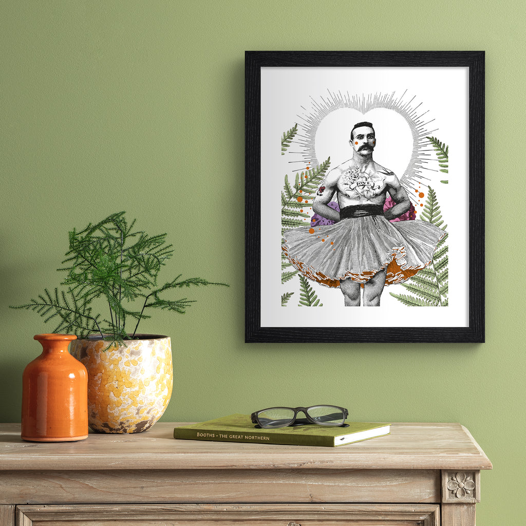 Elegant art print featuring a man standing in a tutu, framed by botanicals and a heart silhouette. Art print is hung up on a green wall.