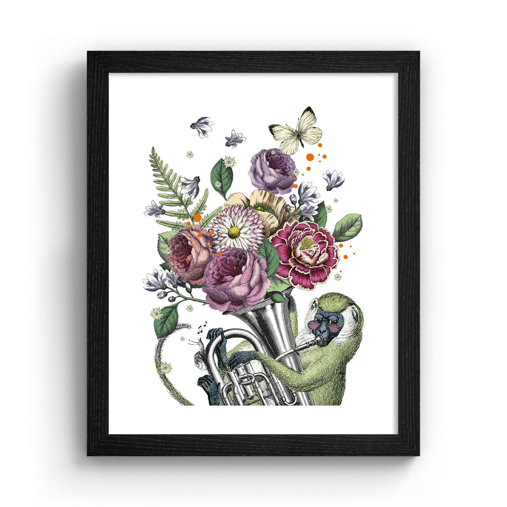 Eclectic art print featuring a monkey playing music with animals and botanicals blooming from the instrument. Art print is in a black frame.