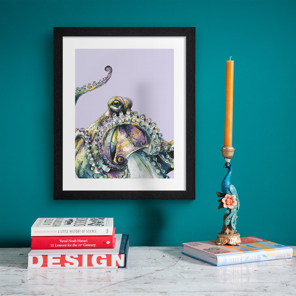 Playful art print featuring a curious octopus poking into the frame, in front of a pale purple background. Art print is hung up on a bright blue wall.