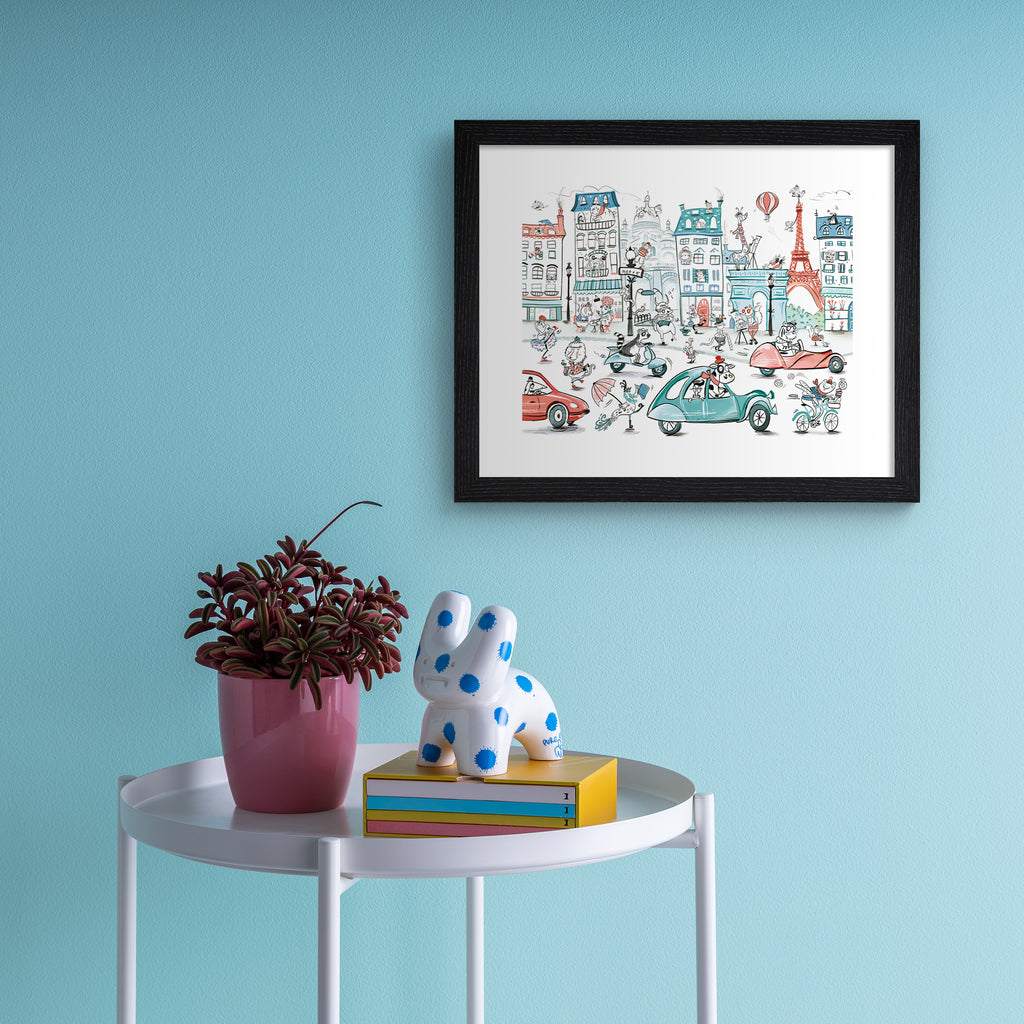 Colourful art print featuring playful animals exploring Paris. Art print is hanging up on a blue wall.