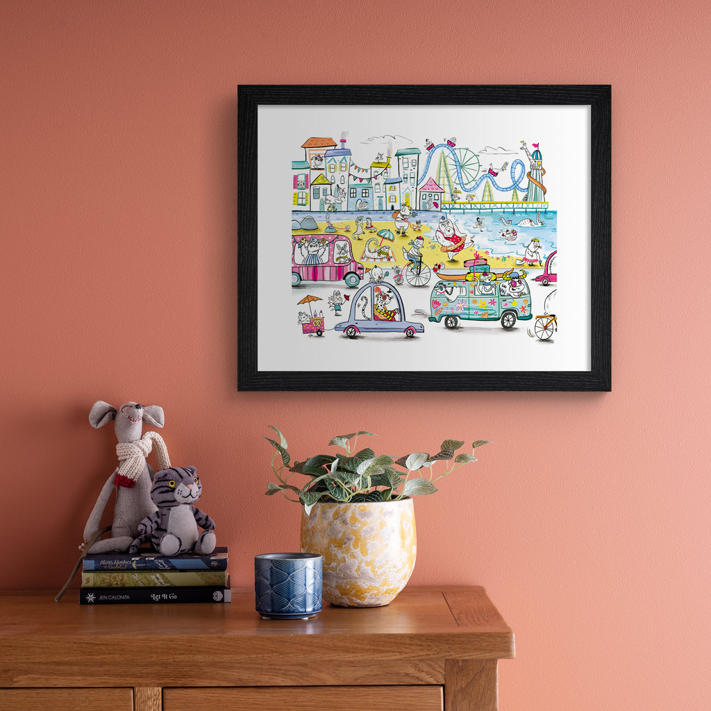 Colourful art print featuring playful animals exploring the seaside, with fun and iconic landmarks in the background. Art print is hung up on a pink wall.