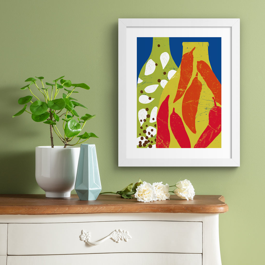 Bright art print featuring two patterned bottles of infused oil, in front of a bright blue background. Art print is hung on a green wall.