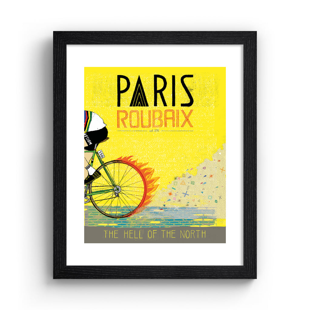 Bright art print featuring a person cycling past on a yellow background. Title above reads 'Paris, Roubaix'. Art print is in a black frame.