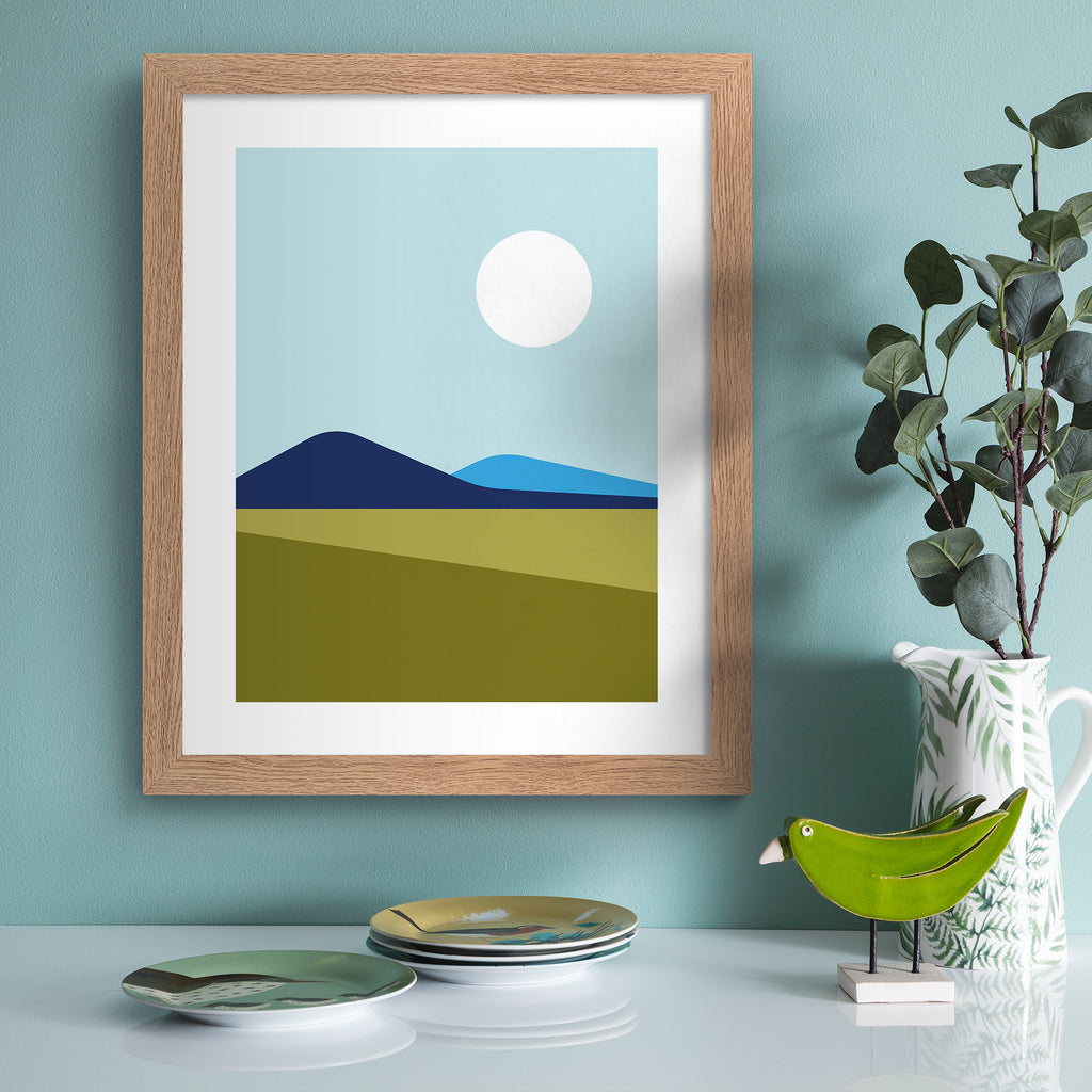 Minimalistic print featuring a beautiful mountain landscape. Art print is hung up in a blue frame.