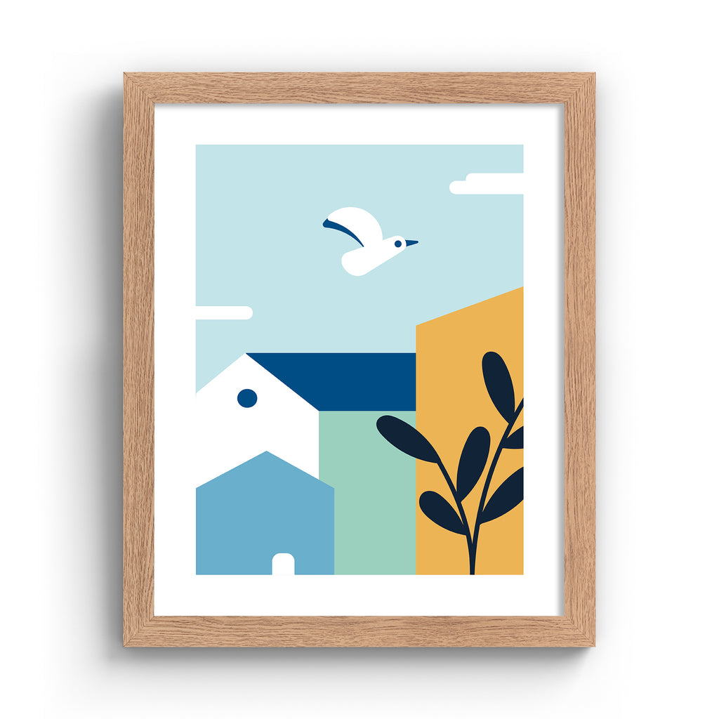 Minimalistic art print featuring a coastal bird flying over colourful houses. Art print is in an oak frame.