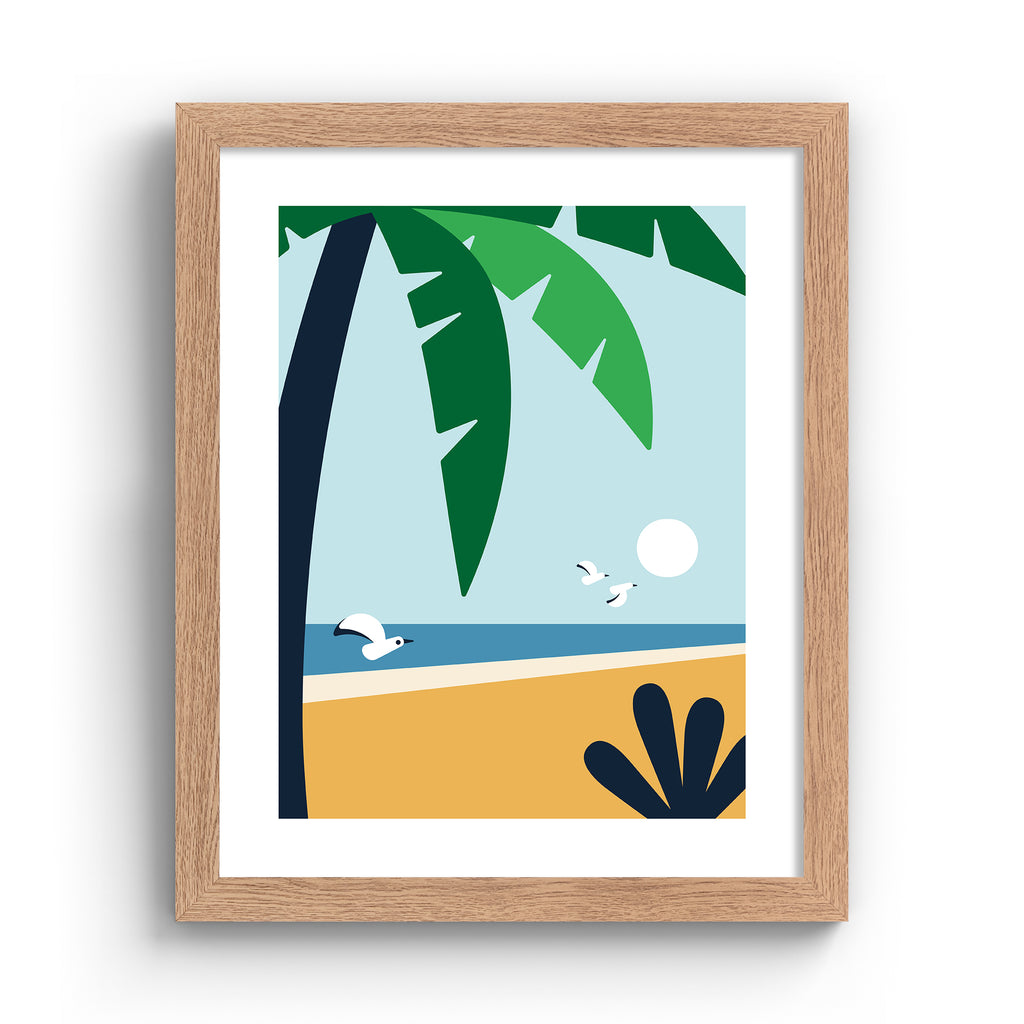 Minimalistic print featuring a palm tree standing in front of a beautiful coastal scene. Art print is in an oak frame.