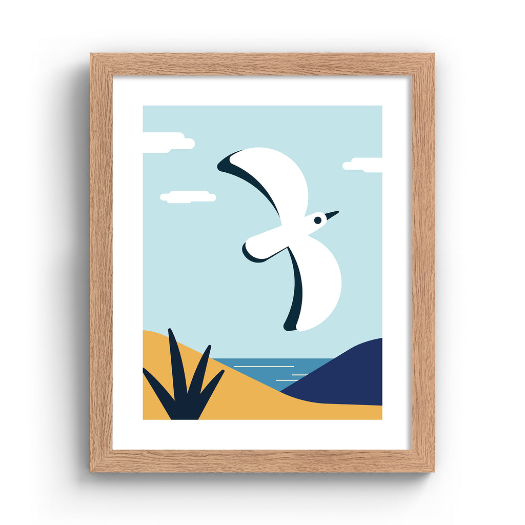 Colourful art print featuring a bird flying in front of a coastal scene. Art print is in an oak frame.