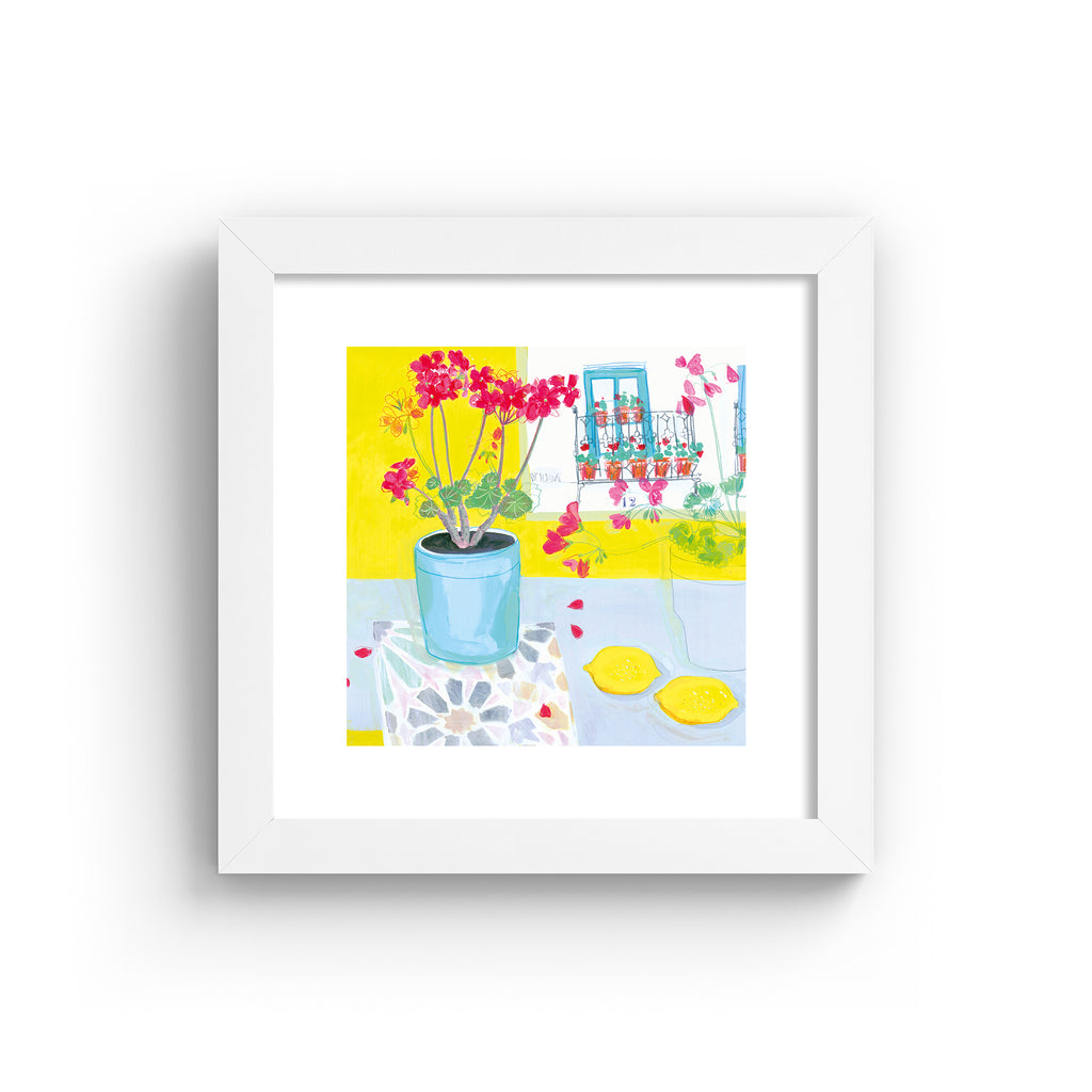 Vibrant art print featuring a vase of pink flowers next to yellow fruit and walls, in a white frame.