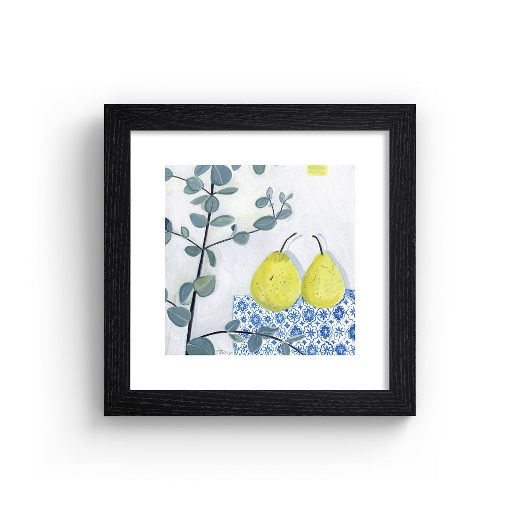 Minimalistic art print featuring two pears laid out on a blue patterned tablecloth. Art print is in a black frame.