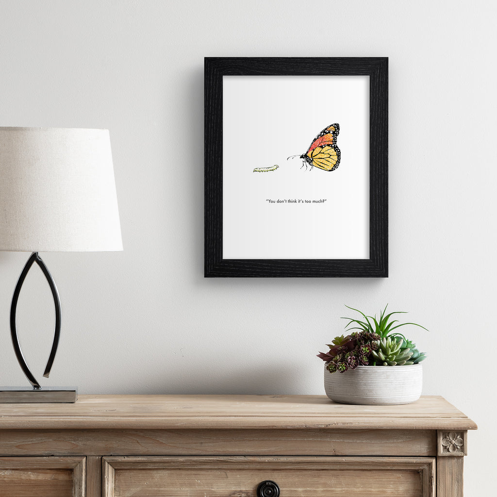 Humorous art print featuring an illustration of a butterfly standing with a caterpillar. Title below reads 'You don't think it's too much?'. Art print is hung up on a white wall.