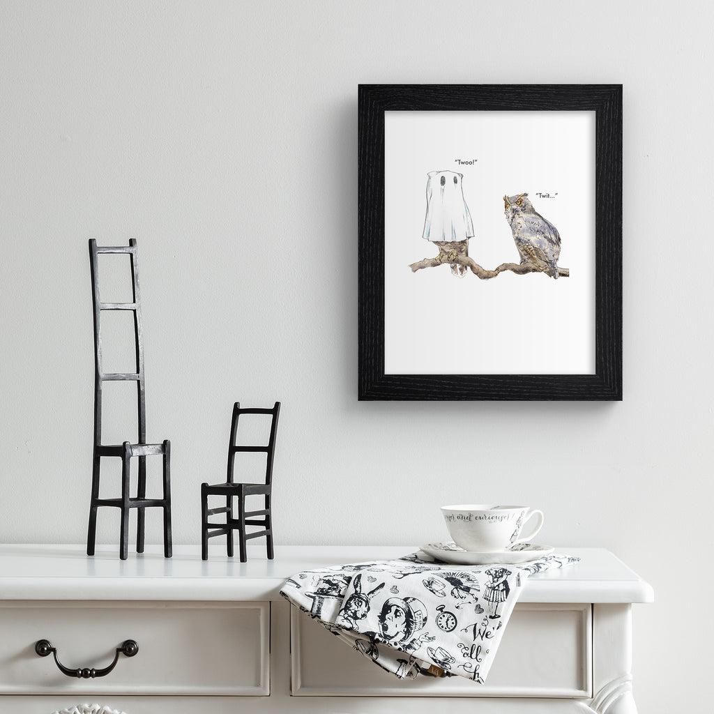 Humorous art print featuring an illustration of two owls perched together. One owl wears a ghost costume and says 'Twoo!' Art print is hung up on a white wall.