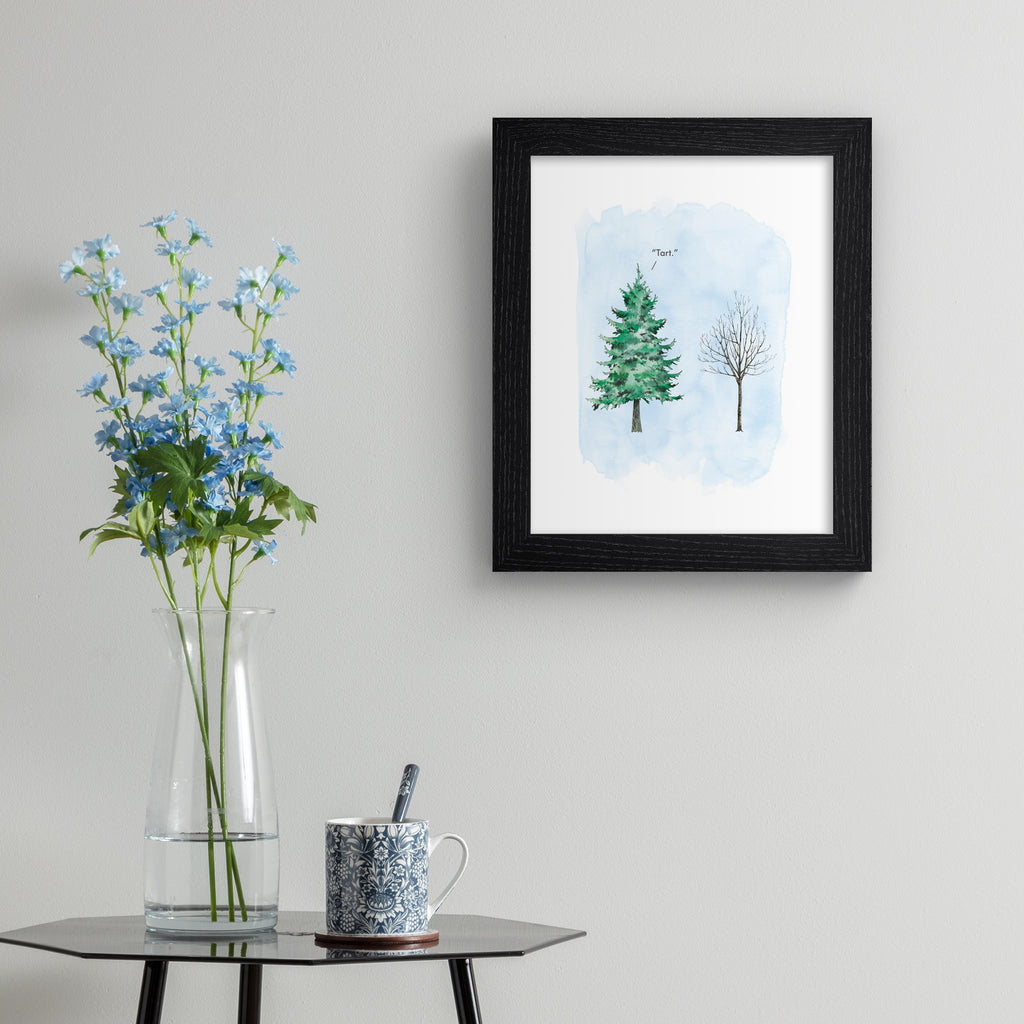 Humorous art print featuring an illustration of a flourishing tree next to a wintery tree with no leaves. Title above tree reads 'Tart'. Art print is hung up on a grey wall.