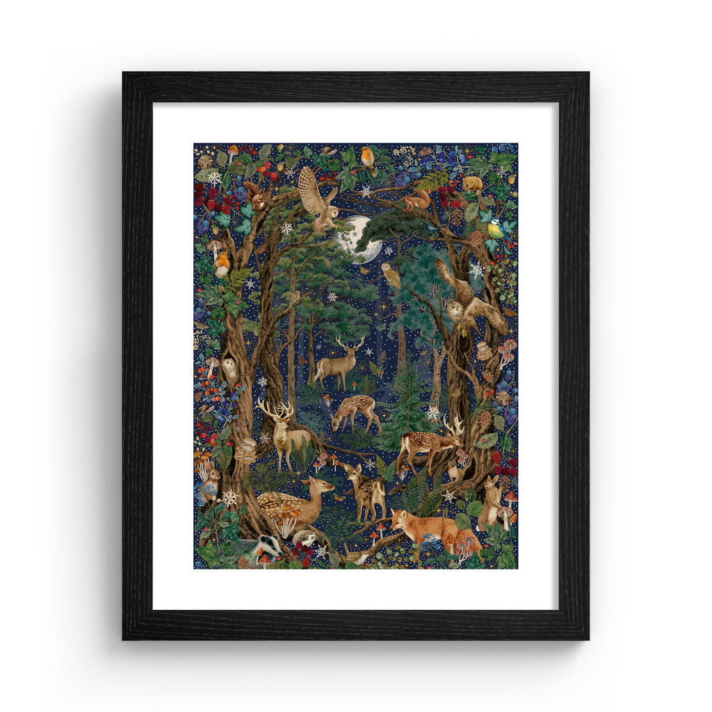 Stunning Christmas art print featuring a collection of British wildlife and botanicals in a forest under a star-studded night sky. Art print is in a black frame.