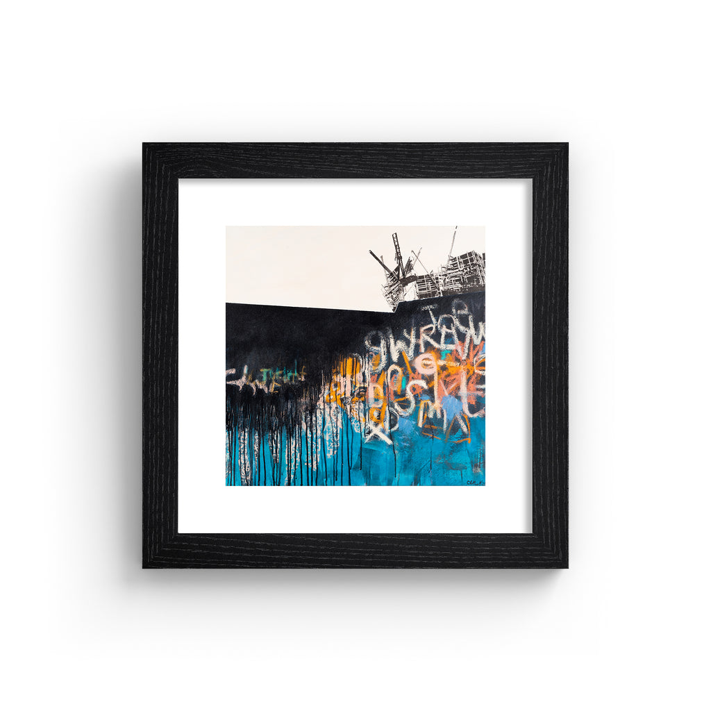Vivid abstract print featuring an urban landscape covered in black, blue, white and orange graffiti. Art print is in a black frame.