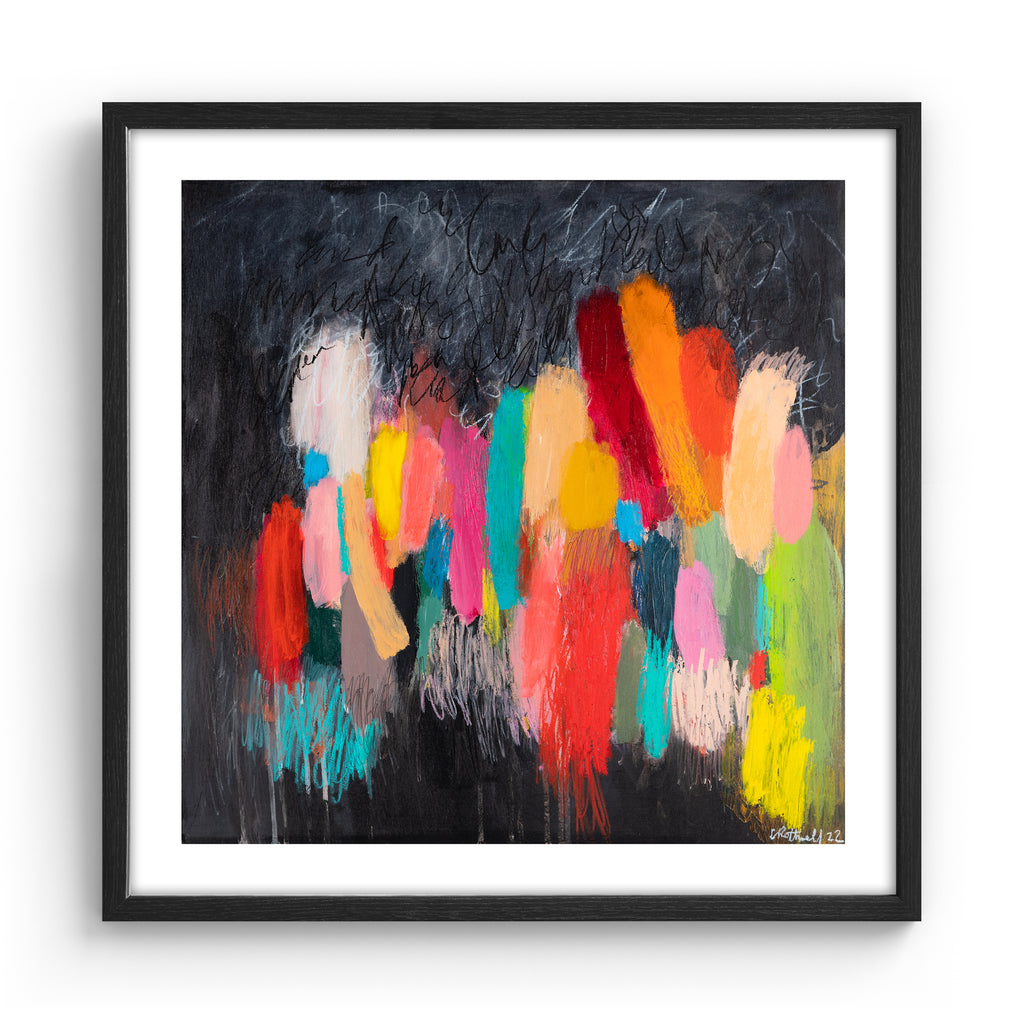 Large version of the vivid abstract print features a vast array of bright colours blended on a moody background. Art print is in black frame.