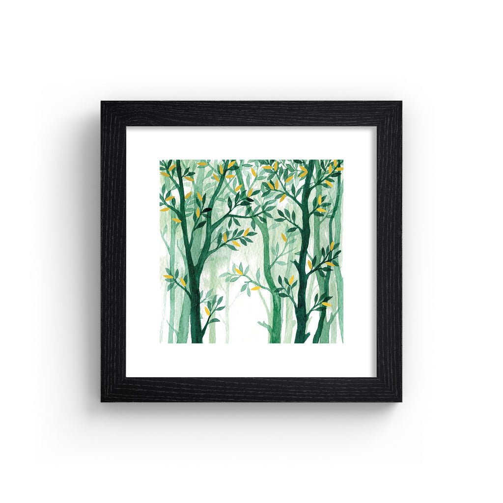 Nature wall art print featuring a forest of vibrant green trees with gold leaves, in a black frame.