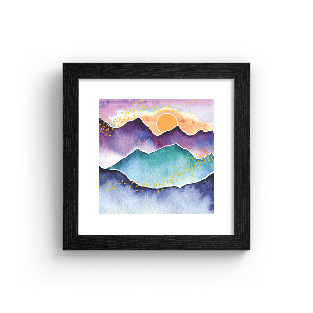 Watercolour art print featuring the sun rising above a beautiful mountain landscape. Art print is in a black frame.