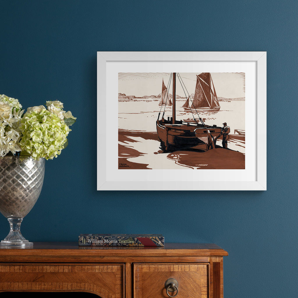 Classical watercolour art print featuring boat near a shoreline, hung up on a blue wall.