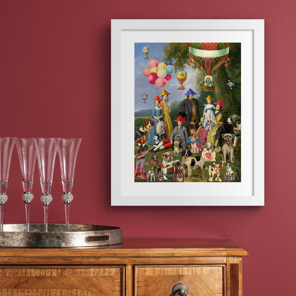 Vibrant art print featuring a 'dog picnic' of people, dogs and characters on a lawn. Art print is hung up on a red wall.